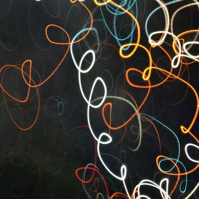 Abstract image showing flowing lines of light against a dark background.